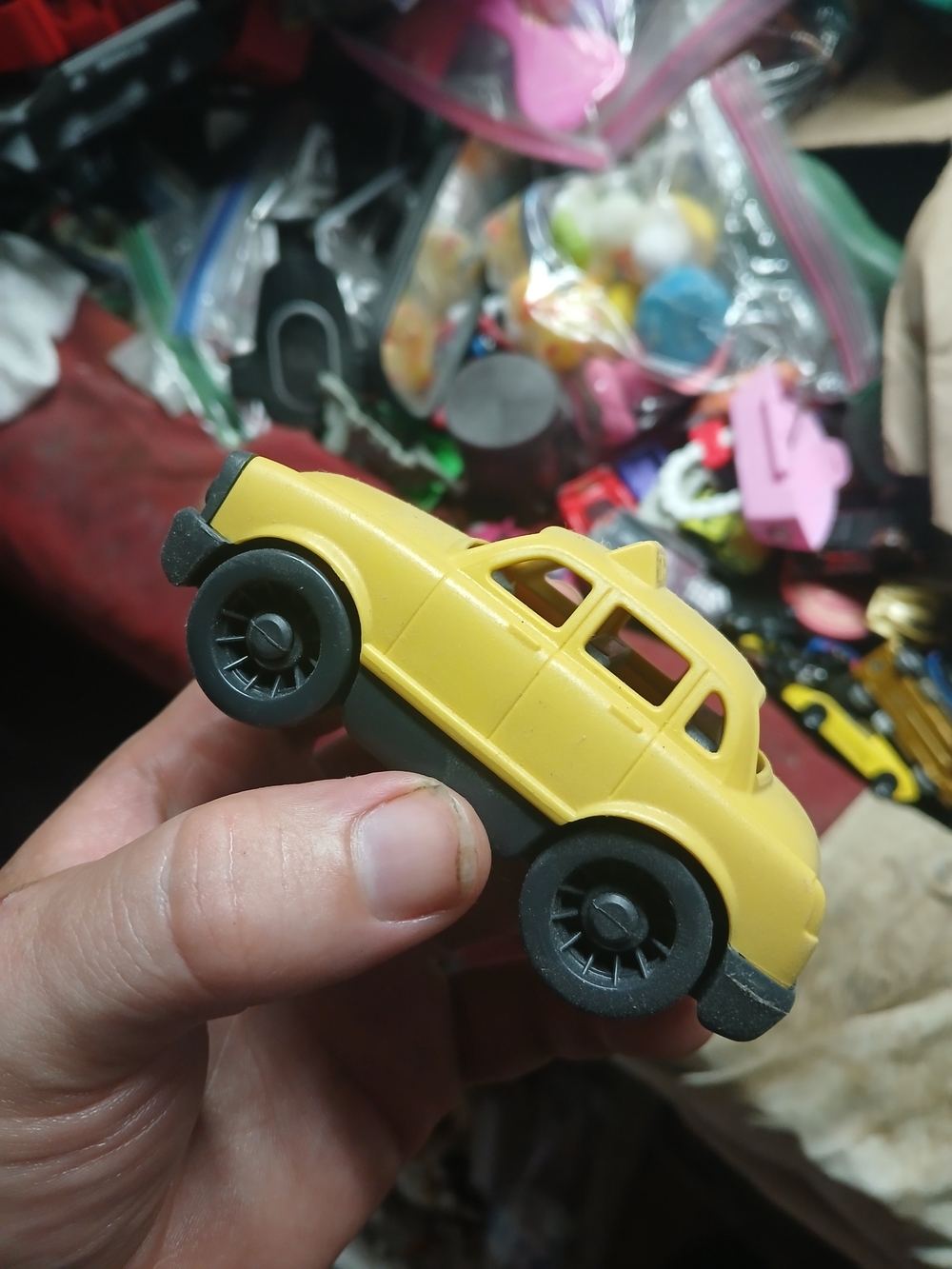 a bright yellow Green Toys Mini Yellow Taxi